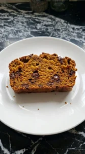 Pumpkin Bread with Chocolate Chips sliced to show moist orange crumb and chocolate pockets Recipe focus: pumpkin loaf with chocolate chips.