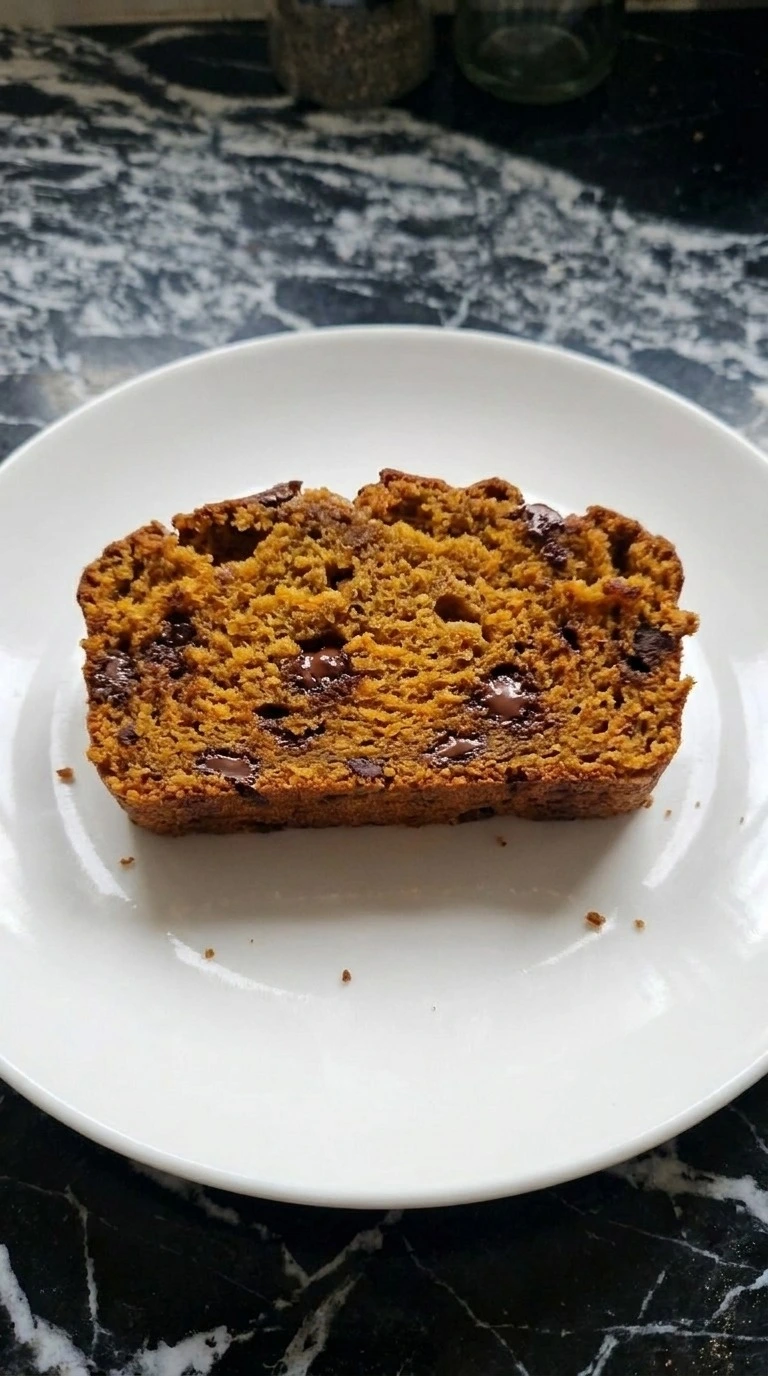 Pumpkin Bread with Chocolate Chips sliced to show moist orange crumb and chocolate pockets Recipe focus: pumpkin loaf with chocolate chips.