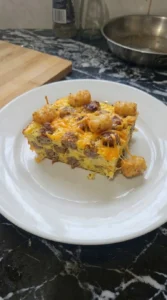 Tater Tot Breakfast Casserole single serving with visible layers Recipe focus: hashbrown breakfast casserole.