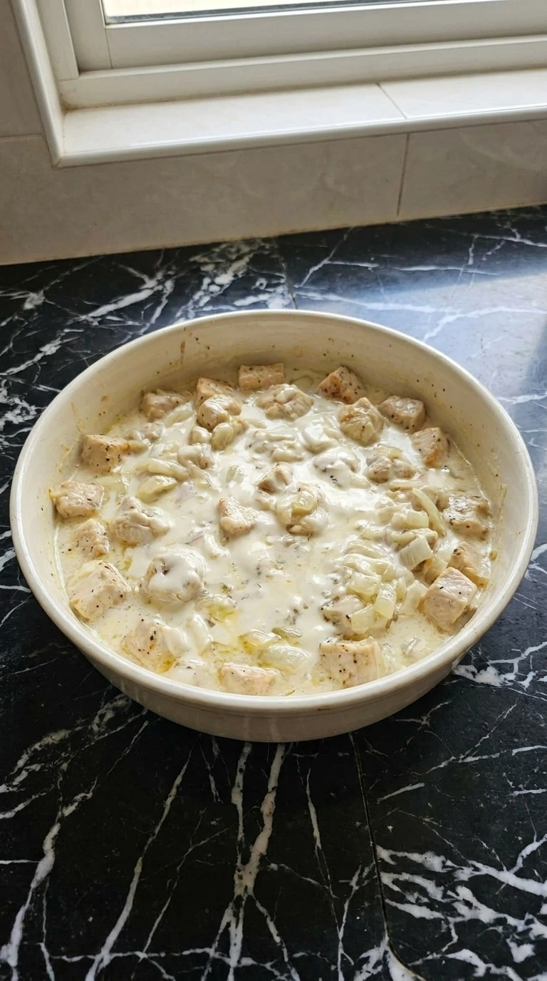 White Chicken Lasagna Soup creamy broth forming with chicken and cheese Recipe focus: white lasagna soup.