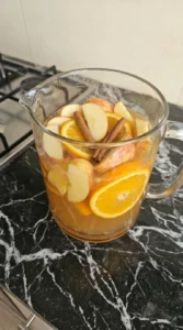Apple Cider Sangria sliced apples and orange soaking in cider Recipe focus: spiced apple cider sangria.