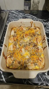Biscuits and Gravy Breakfast Casserole baking with golden biscuit topping Recipe focus: breakfast casserole with hashbrowns.