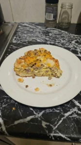 Biscuits and Gravy Breakfast Casserole serving slice with visible layers Recipe focus: easy breakfast casserole.