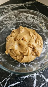 Mixing soft tan dough for Browned Butter Halloween Candy Cookies before adding candy