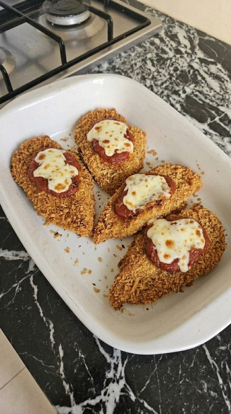 Chicken Parmesan baked with thick marinara and melted mozzarella over four crispy golden cutlets. Recipe focus: chicken parmesan recipe.
