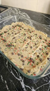 Christmas Cookie Bars dough spread in baking pan before oven baking Recipe focus: christmas cookie bars easy.