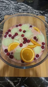 Christmas Sherbet Punch finished with cranberries orange slices and sherbet Recipe focus: christmas punch non alcoholic.