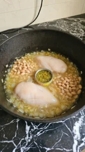 Creamy White Chicken Chili simmering with two chicken breasts, Great Northern beans and diced Hatch green chiles Recipe focus: crockpot white chicken chili.