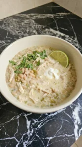Creamy White Chicken Chili served with melting Monterey Jack cheese, sour cream, cilantro and a lime wedge Recipe focus: white chicken chili easy.