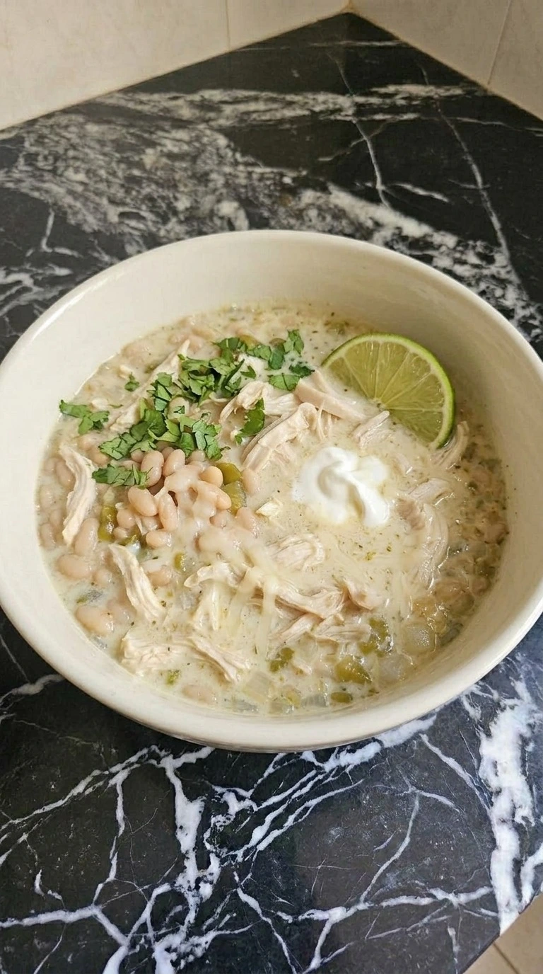 Creamy White Chicken Chili served with melting Monterey Jack cheese, sour cream, cilantro and a lime wedge Recipe focus: white chicken chili easy.