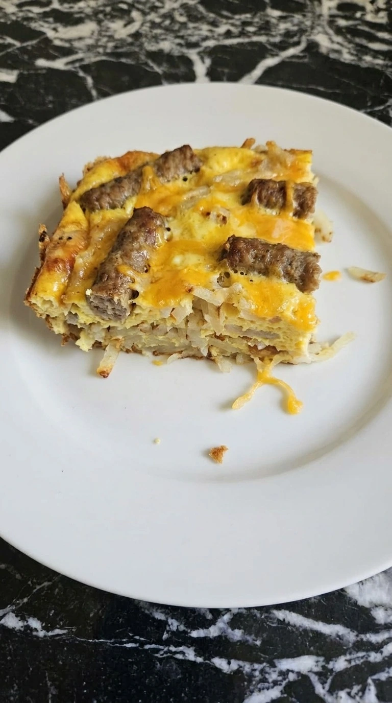 Crockpot Breakfast Casserole sliced portion showing egg hashbrown and cheese layers Recipe focus: easy breakfast casserole.