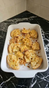 Croissant Breakfast Casserole baking with melted cheddar and golden croissant top Recipe focus: breakfast casserole with hashbrowns.