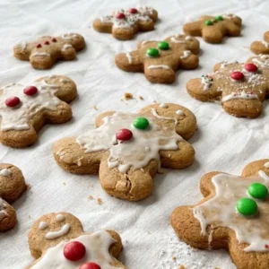 Gingerbread Man Cookies on a plate with golden edges and simple icing details Recipe focus: gingerbread cookies.