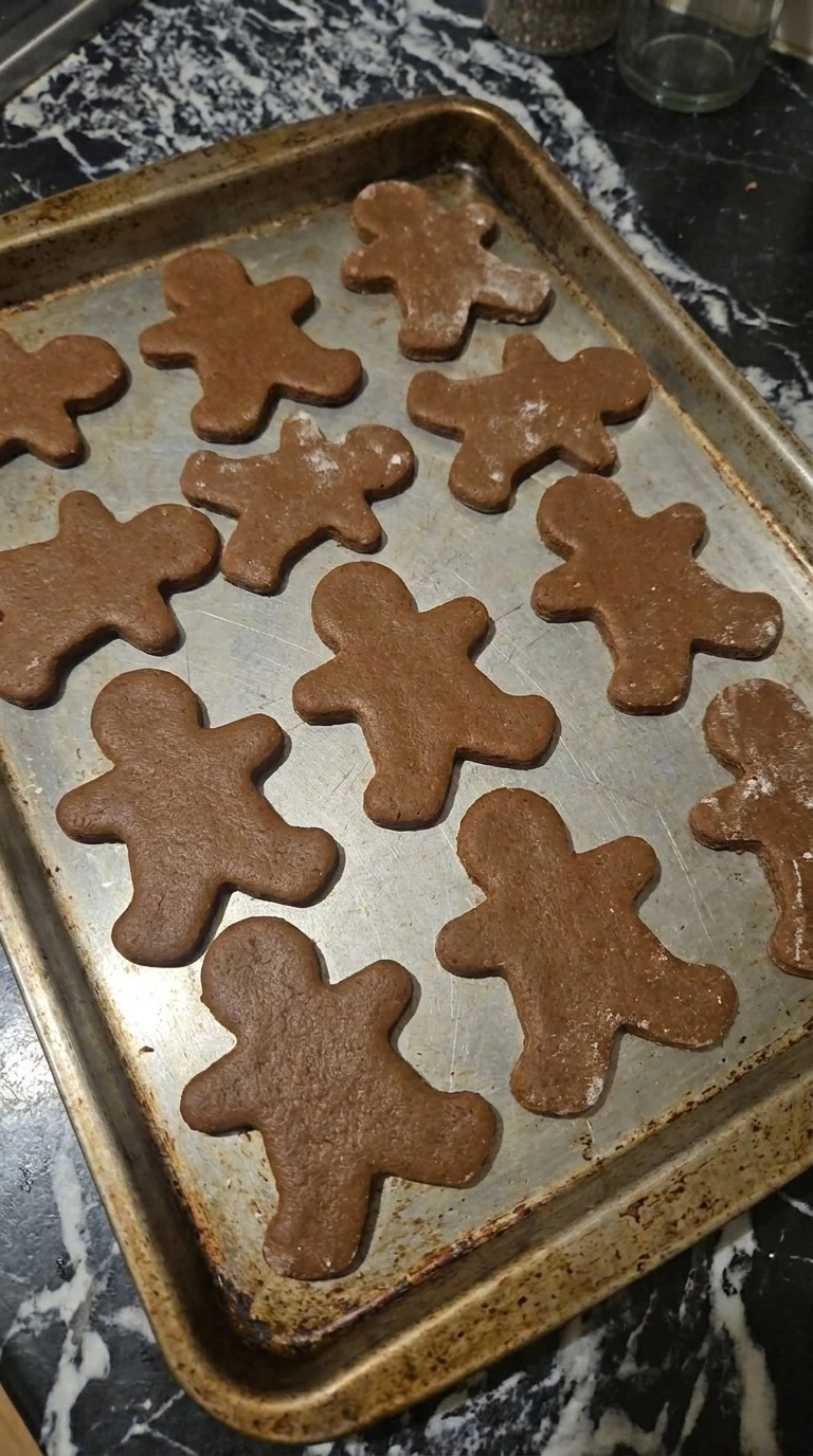 Gingerbread Man Cookies cut from chilled dough before baking Recipe focus: gingerbread cookies.
