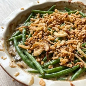 Green Bean Casserole with Fresh Green Beans finished with golden crispy topping in serving dish Recipe focus: green bean casserole easy.