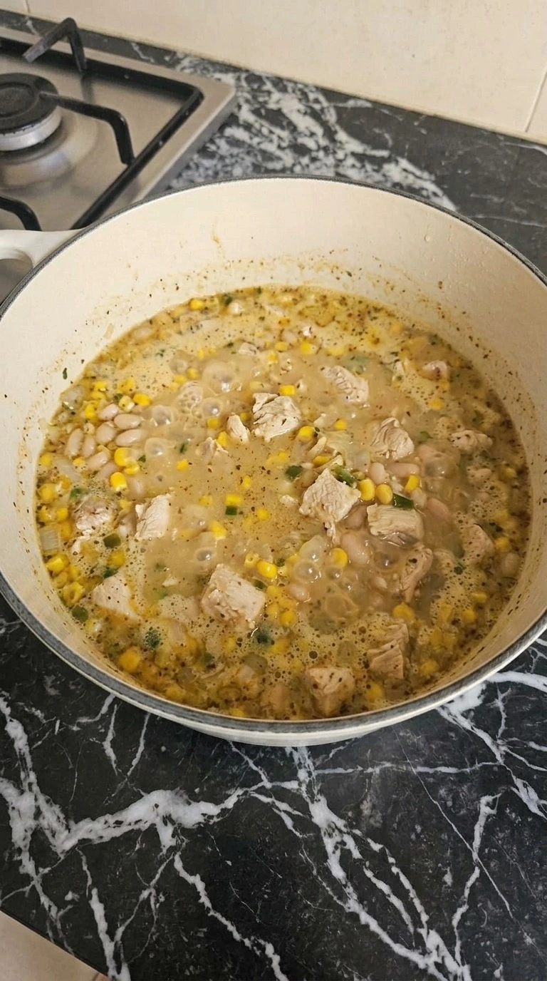 Mexican Street Corn White Chicken Chili simmering with chicken corn and creamy broth Recipe focus: crockpot white chicken chili.