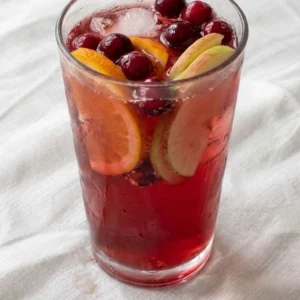 Non Alcoholic Christmas Punch in a glass with citrus slices and cranberries Recipe focus: christmas punch non alcoholic.