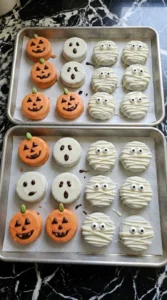 Oreo Cookies Decorated for Halloween with chocolate pumpkin faces and ghost eyes and mummy stripes