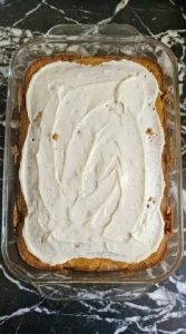 Pumpkin Bars with Cream Cheese Frosting topped with white frosting layer Recipe focus: pumpkin bars recipe.