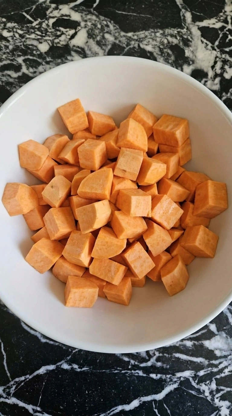 Peeled orange sweet potato cubes cut into 1-inch pieces for Slow Cooker Mashed Sweet Potatoes. Recipe focus: easy slow cooker mashed sweet potatoes.