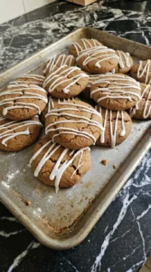 Soft Gingerbread Cookies with icing drizzled over cracked tops Recipe focus: soft chewy gingerbread cookies.