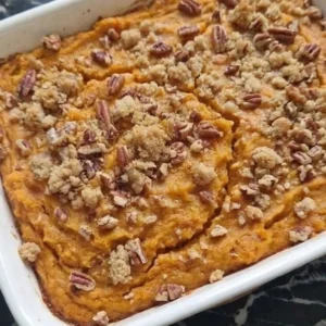 Sweet Potato Casserole with Pecans baked with golden pecan topping in serving dish Recipe focus: ruth chris sweet potato casserole.