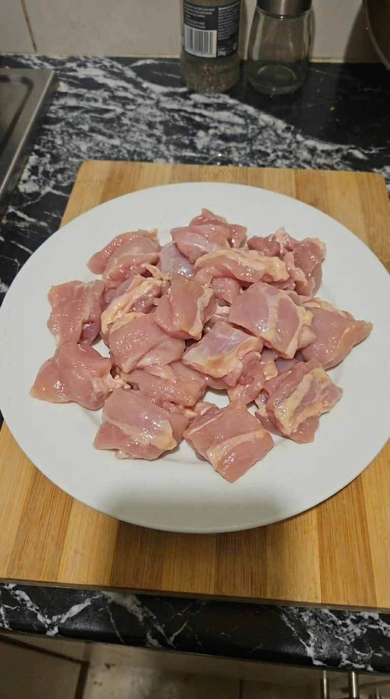 Teriyaki Chicken preparation with raw boneless chicken thighs cut into uneven bite-sized pieces Recipe focus: teriyaki chicken recipe.