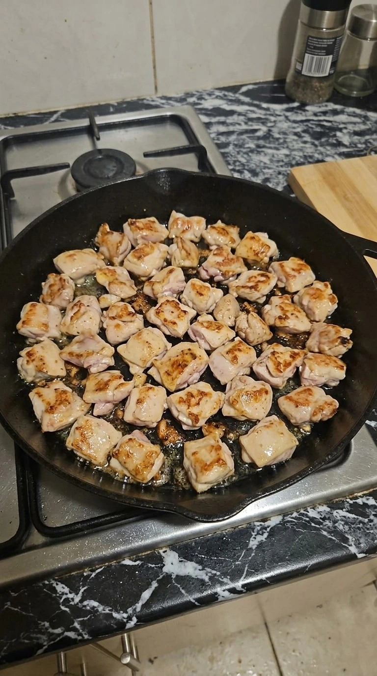 Teriyaki Chicken pieces searing in a cast iron skillet with golden edges and lightly caramelized surfaces Recipe focus: easy teriyaki chicken.