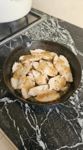 Thanksgiving Leftover Sandwich turkey slices warming in brown gravy with dried thyme Recipe focus: thanksgiving leftover sandwich recipe.